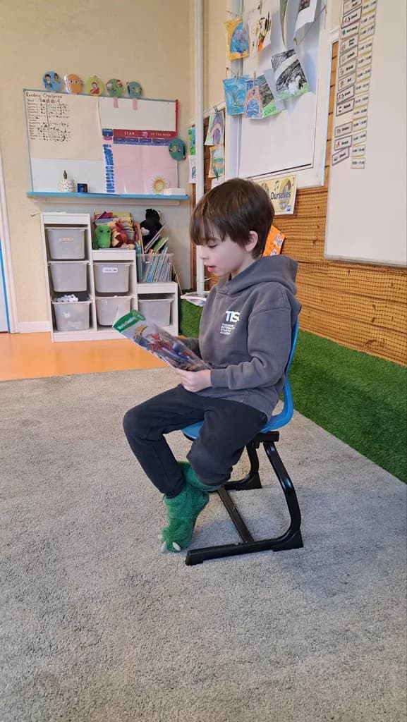 Student reading a book in the classroom reading corner during Golden Hour
