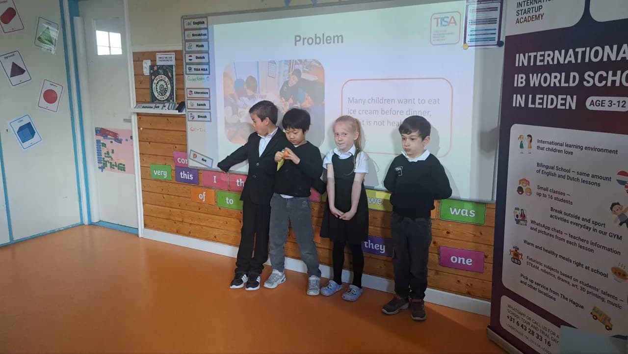 Four TISA MBA students pitching their Problem slide under the TISA banner