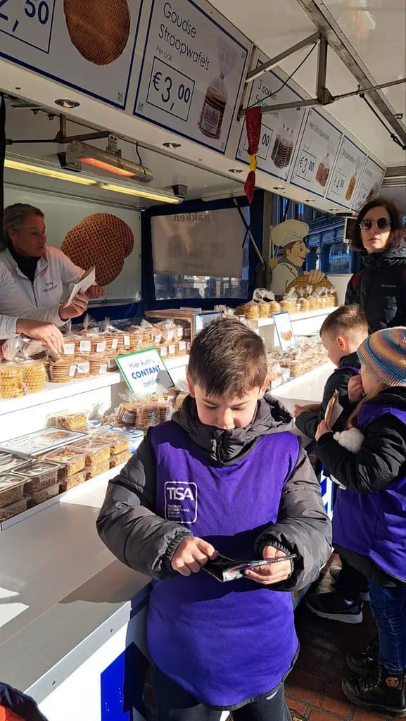 TISA MBA student counting money at a real stroopwafel market stall
