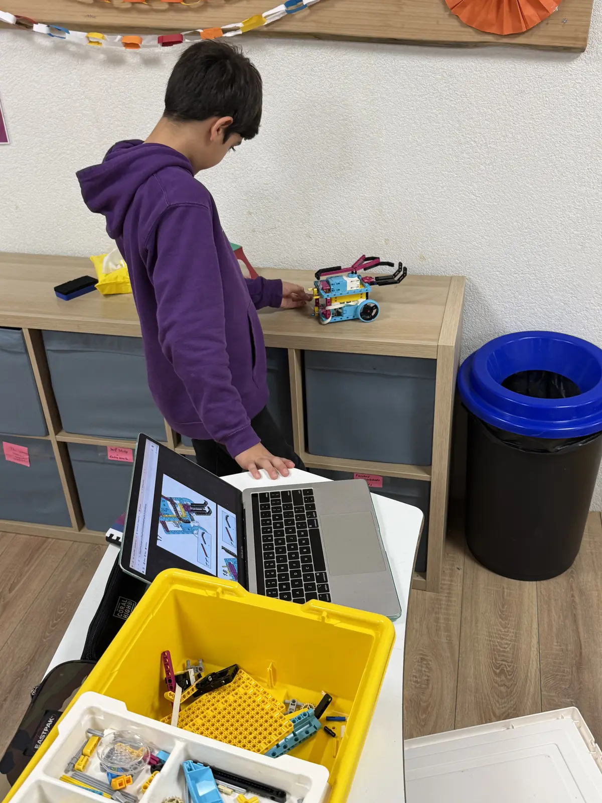 Student programming a robot during a STEM Inventor Lab session at TISA Leiden
