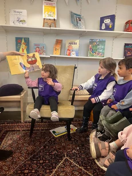 Teacher reading a picture book to young Grade 0 children